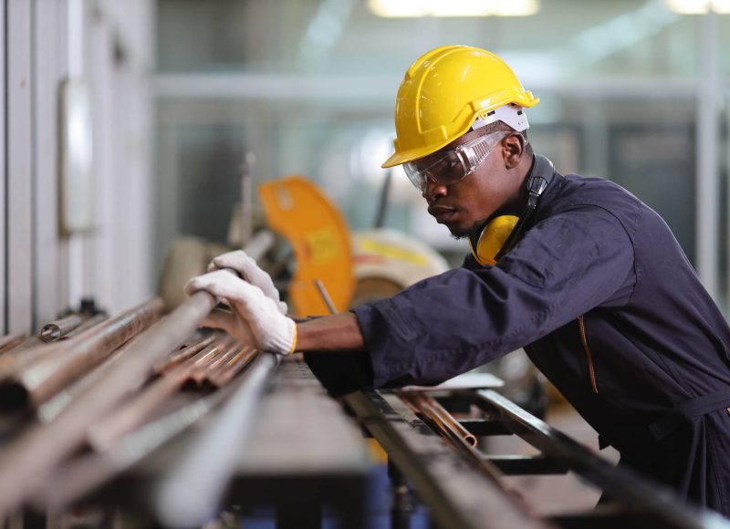 African American mechanic engineer worker is choosing copper tub